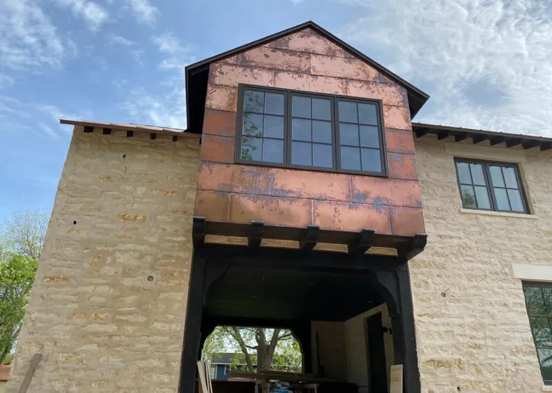Copper metal panel facade on a stone building for Skylight Installation in Carrollton