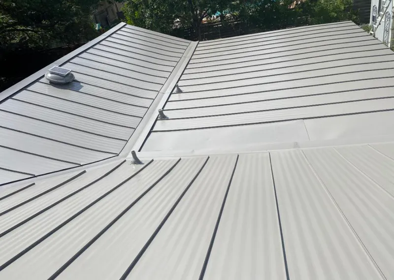 Solar attic fan installed on a metal roof for Roof Ventilation in Carrollton